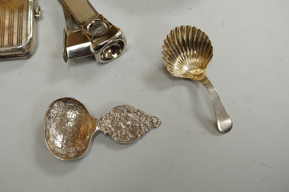 Small silver including two Edwardian caddy spoons, one German with import marks, a George V vesta case, a late Victorian pierced bonbon dish and a modern mounted steel cigar cutter.